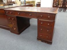 A Victorian twin pedestal writing desk with nine drawers