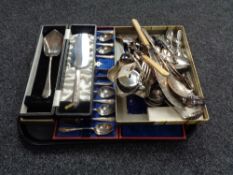 A tray of assorted boxed and loose cutlery and servers