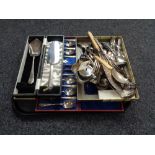 A tray of assorted boxed and loose cutlery and servers