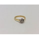 An 18ct gold seven stone diamond cluster ring, size K CONDITION REPORT: 2.