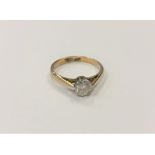 An 18ct gold and platinum diamond solitaire ring, the brilliant cut stone weighing approximately 0.