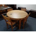 A Laura Ashley circular oak dining table and four leather seated chairs