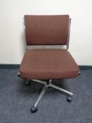 A mid 20th century swivel office chair on chrome base