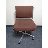 A mid 20th century swivel office chair on chrome base