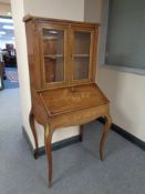 A French inlaid rosewood bureau bookcase with gilt metal mounts