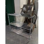 A set of wire metal open shelves and a stainless steel hand sink