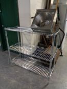 A set of wire metal open shelves and a stainless steel hand sink