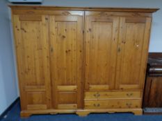 A Jaycee pine four door wardrobe fitted with two drawers