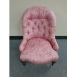 A Victorian lady's chair in pink button fabric