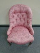 A Victorian lady's chair in pink button fabric