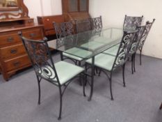 A glass-topped and wrought iron based dining table,