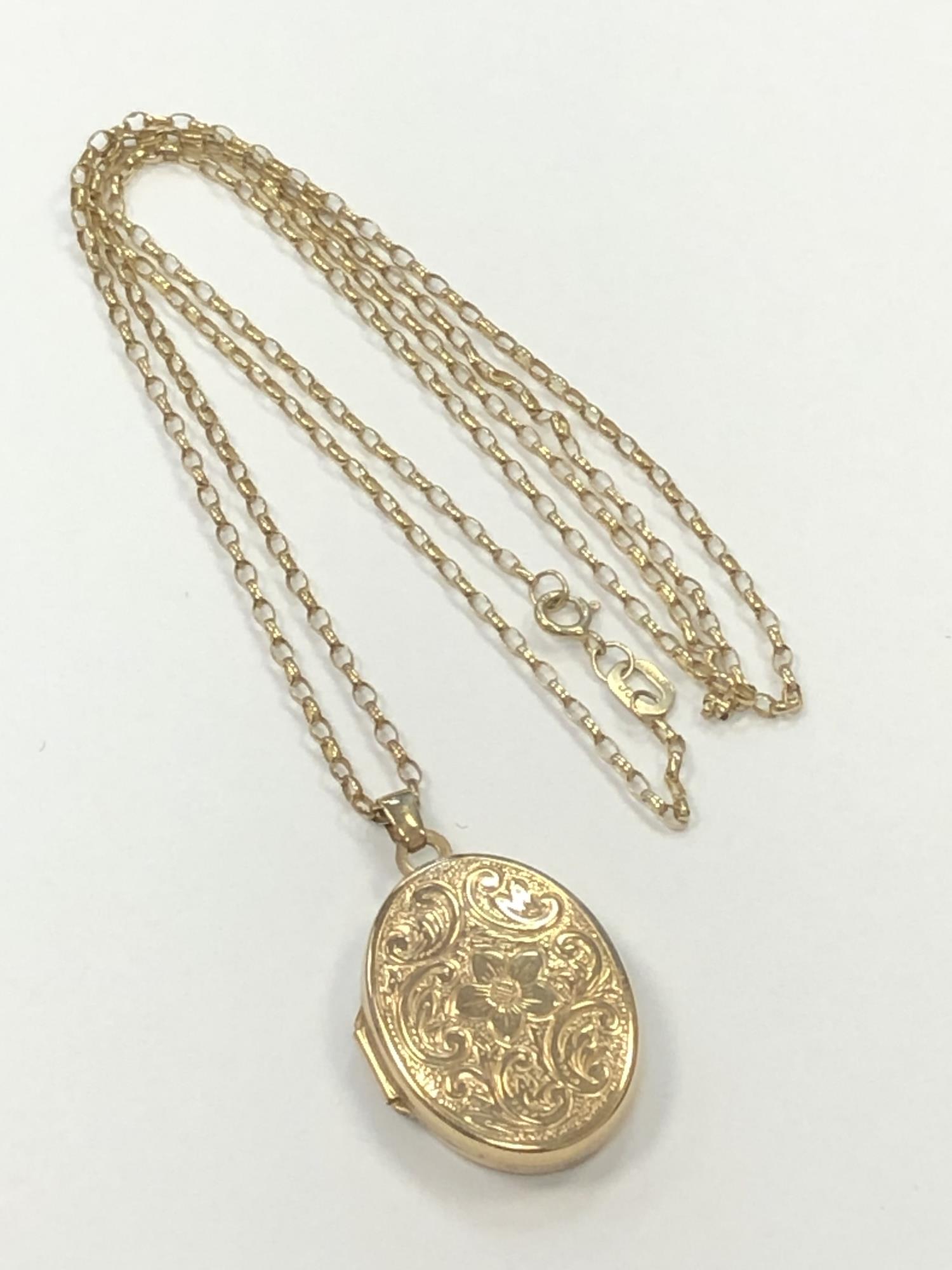 A 9ct gold locket on similar chain CONDITION REPORT: 3.0g gross.