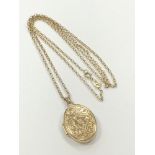 A 9ct gold locket on similar chain CONDITION REPORT: 3.0g gross.