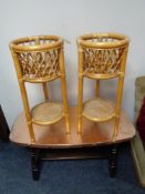 A copper finish coffee table and a pair of bamboo and wicker plant stands