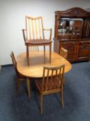 A 20th century teak G Plan extending dining table and five rail back chairs