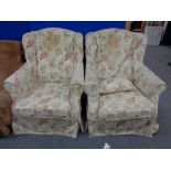 A pair of wing backed armchairs with loose floral covers CONDITION REPORT: These