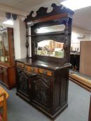 An Edwardian mahogany serpentine fronted mirror backed sideboard