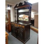 An Edwardian mahogany serpentine fronted mirror backed sideboard