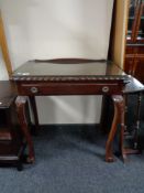 A stained beech wood hall table on claw and ball feet