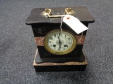 A Victorian black slate and marble mantel clock with brass and enamelled dial