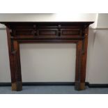 An Edwardian oak fire surround