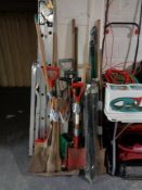 Six bundles of assorted garden tools and a set of drain rods