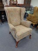 A reproduction Queen Anne style armchair in floral covering