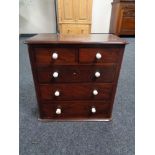An early 19th century mahogany five drawer apprentice chest
