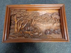 A carved hardwood frieze panel depicting elephants