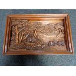 A carved hardwood frieze panel depicting elephants