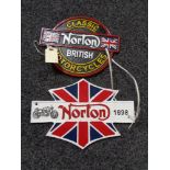 Two metal Norton plaques