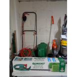 A boxed Qualcast hedge trimmer and Qualcast lawn mower