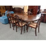 A Regency style twin pedestal dining table and six Hepplewhite style chairs
