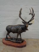 A metal figure - Stag on wooden base