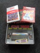 A boxed Atari 7800 together with eighteen boxed games