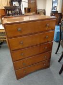 A mid 20th century five drawer oak chest