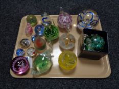 A tray of seventeen glass paperweights