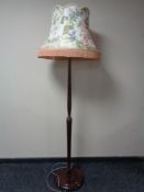 An early 20th century standard lamp with tasseled shade