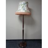An early 20th century standard lamp with tasseled shade