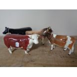 Four Beswick figures - Cows (a/f)