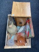 A box of a pine plant stand, place mats, pink glass dessert set,