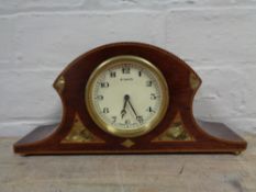 An early twentieth century inlaid mahogany Swiss made eight day mantel clock on brass feet