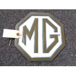 A metal MG plaque