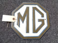 A metal MG plaque