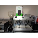 A Fracino stainless steel commercial two cup coffee maker with accessories and an Expobar coffee