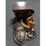 A tray of wooden pieces, miniature three drawer chest, tribal mask, hearth brush,