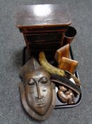 A tray of wooden pieces, miniature three drawer chest, tribal mask, hearth brush,