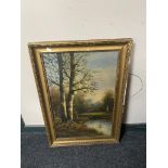 An early twentieth century gilt framed oil on board - figure in rural landscape