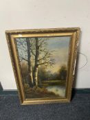 An early twentieth century gilt framed oil on board - figure in rural landscape