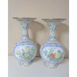 A pair of 20th century floral patterned enamel vases,